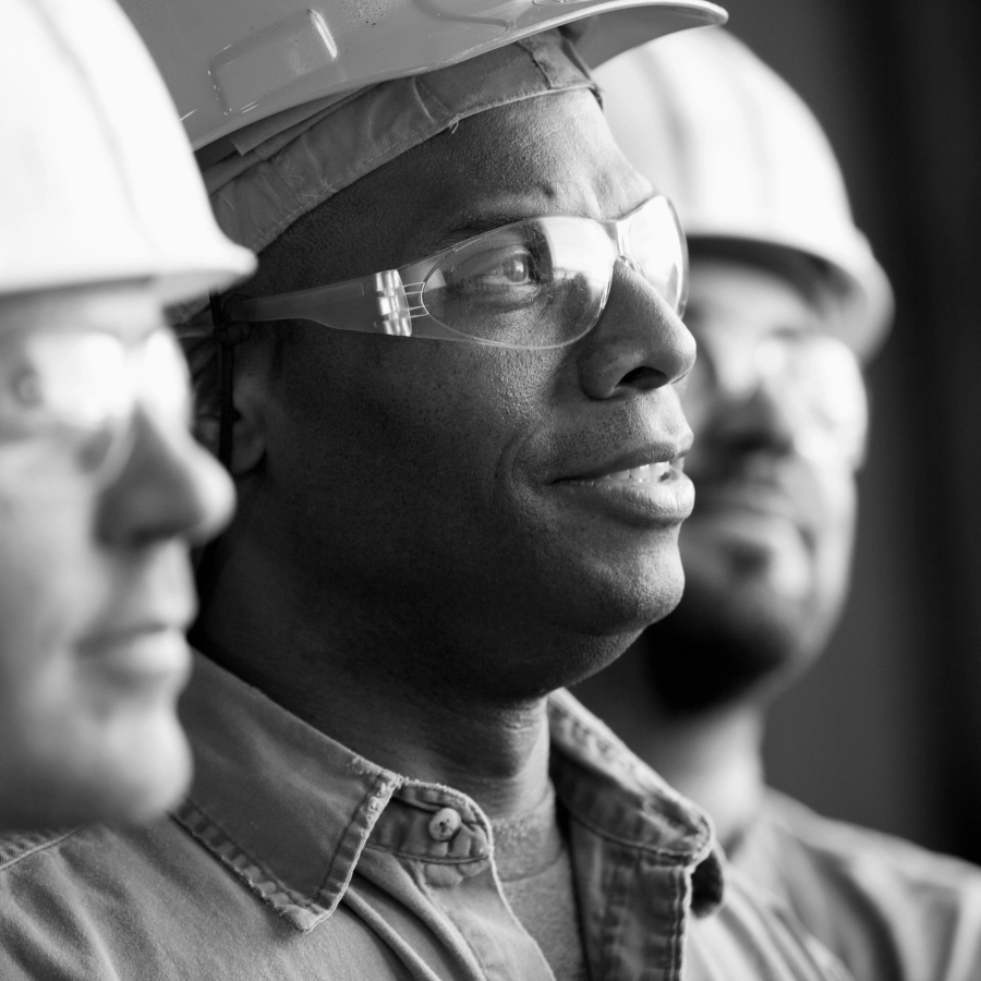 Black and white image of men wearing safety clothing