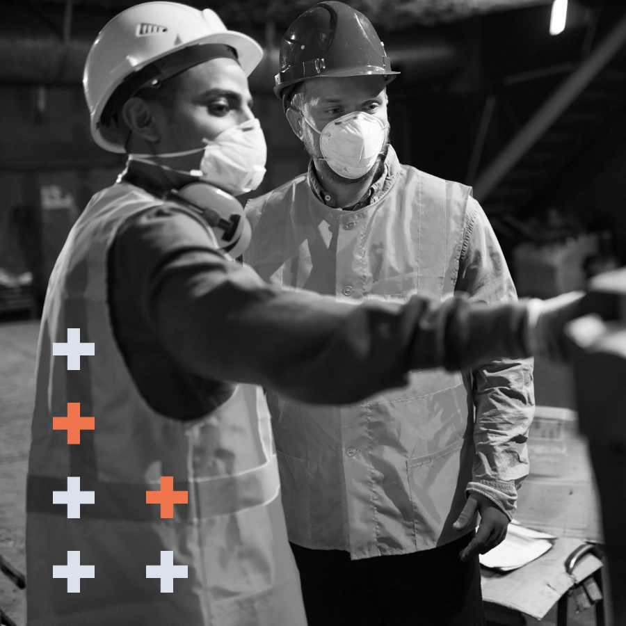 Image of two men wearing protective clothing